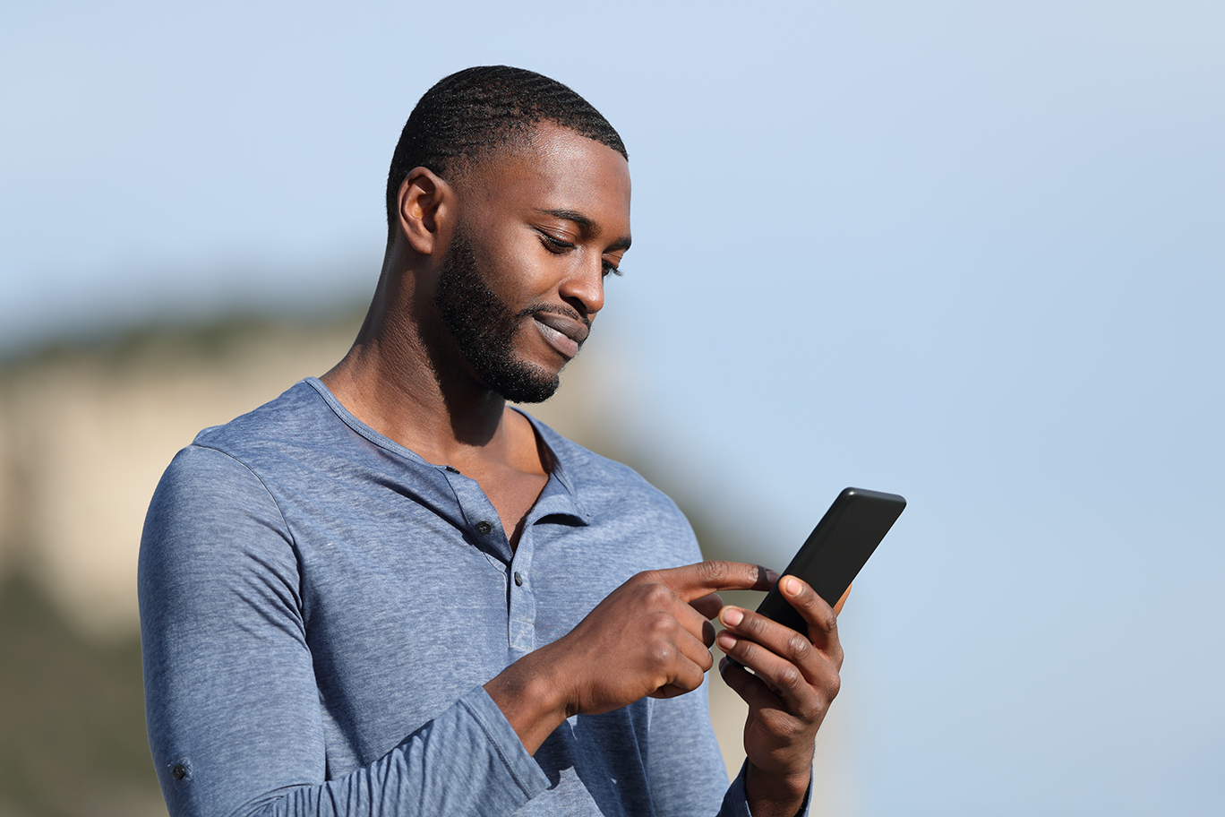 guy looking at phone sm